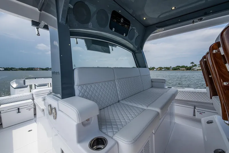Slide: The Image of Luxurious seating on 2025 HCB 48 Campeon boat with quilted upholstery and scenic water view. - 31