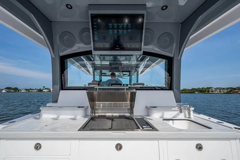 Slide: The Image of 2025 HCB 48 Campeon boat interior with grill and sink, featuring modern design and technology. - 34