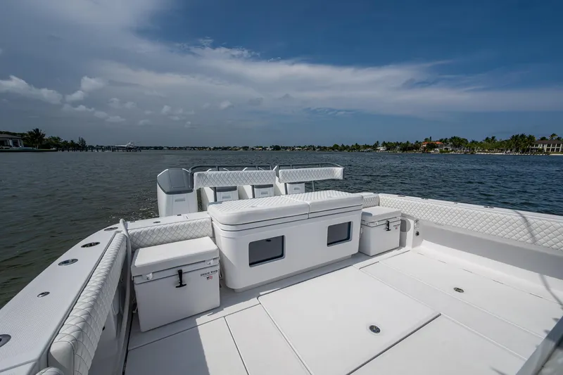 Slide: The Image of 2025 HCB 48 Campeon boat deck with seating, overlooking calm waters and distant shoreline. - 37