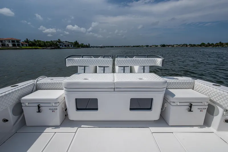 Slide: The Image of 2025 HCB 48 Campeon boat deck with seating and storage, overlooking calm waters. - 38
