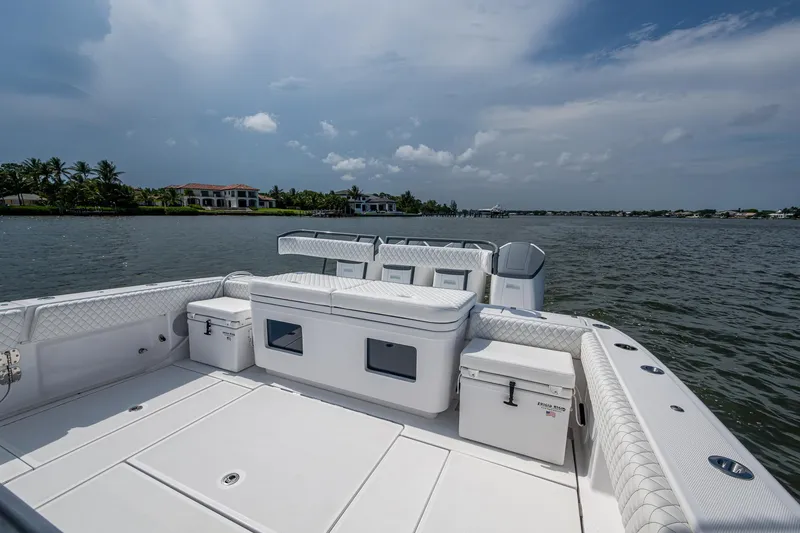 Slide: The Image of 2025 HCB 48 Campeon boat deck with seating, overlooking calm waters and distant shoreline. - 39