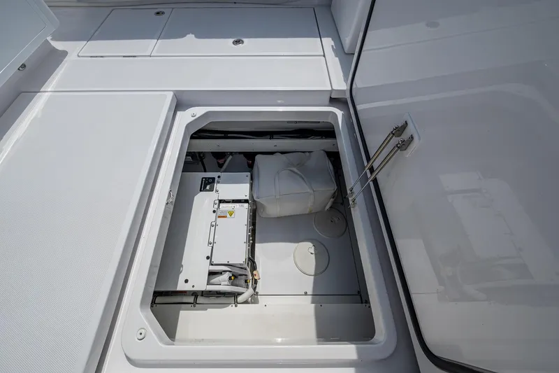 Slide: The Image of 2025 HCB 48 Campeon boat storage compartment with open hatch, showcasing interior equipment. - 43