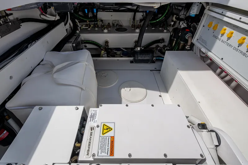 Slide: The Image of Engine compartment of 2025 HCB 48 Campeon boat, featuring electrical distribution panel and equipment. - 63
