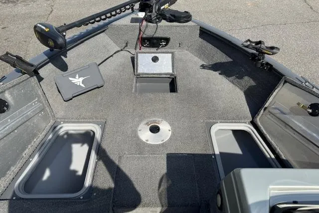 Slide: The Image of 2018 Tracker Pro Guide V-175 SC boat interior with storage compartments and trolling motor. - 12