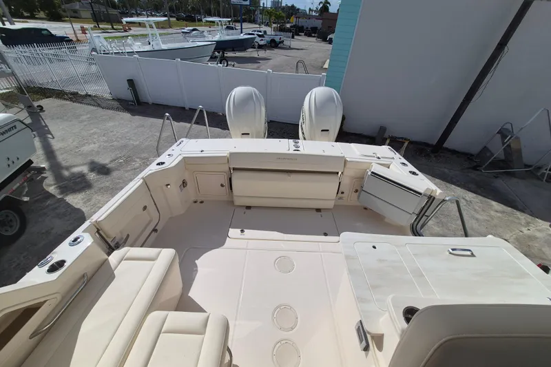 Slide: The Image of 2026 Grady-White Freedom 345 boat interior with seating and dual engines. - 16