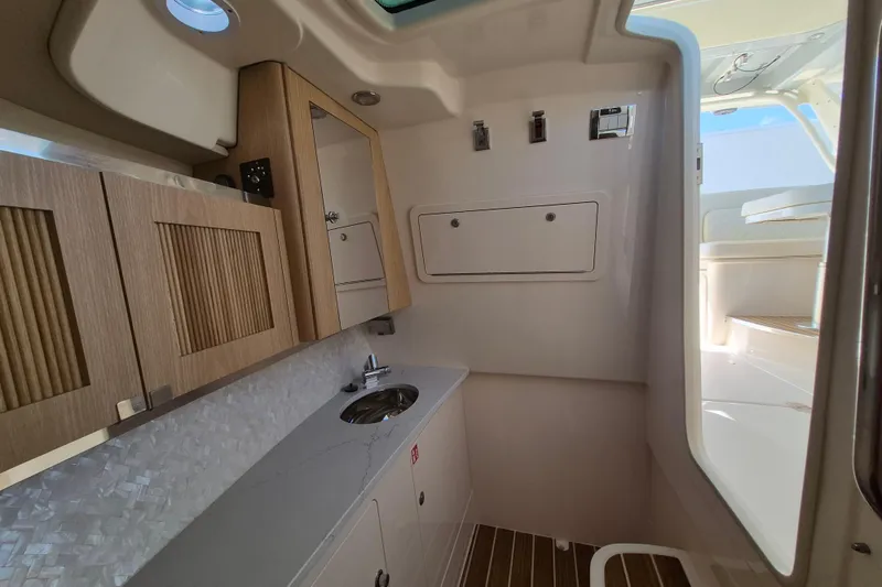 Slide: The Image of Interior of 2026 Grady-White Freedom 345 boat, featuring modern cabinetry and sink. - 20