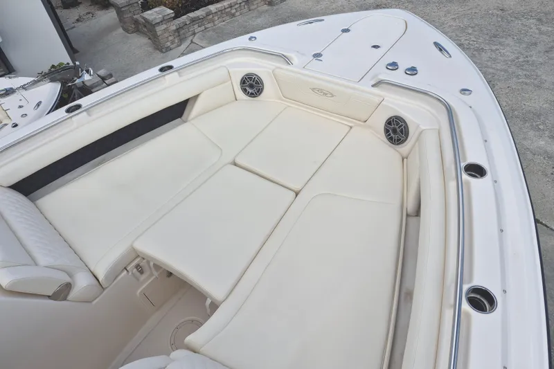 Slide: The Image of 2026 Grady-White Freedom 345 boat interior with spacious white seating and speakers. - 7