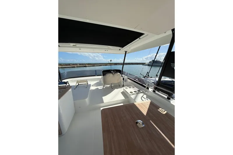 Slide: The Image of 2024 Fountaine Pajot MY 44 yacht interior with helm, seating, and ocean view. - 11