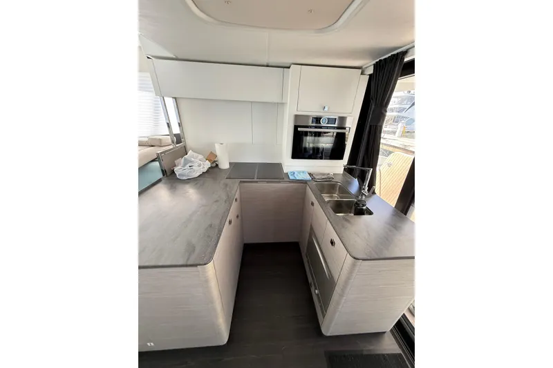 Slide: The Image of Modern kitchen interior of 2024 Fountaine Pajot MY 44 yacht, featuring sleek countertops and appliances. - 13