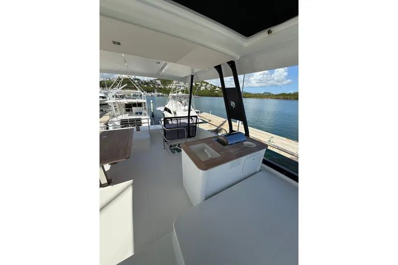Slide: The Image of 2024 Fountaine Pajot Motor Yacht 44 docked in a marina, rear view. - 10