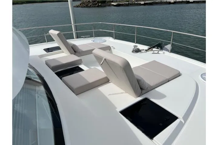 Slide: The Image of Luxury sun loungers on 2024 Fountaine Pajot MY 44 yacht deck, overlooking serene waters. - 32
