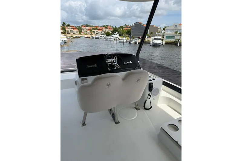 Slide: The Image of 2024 Fountaine Pajot MY6 yacht helm with Garmin navigation, overlooking marina. - 35