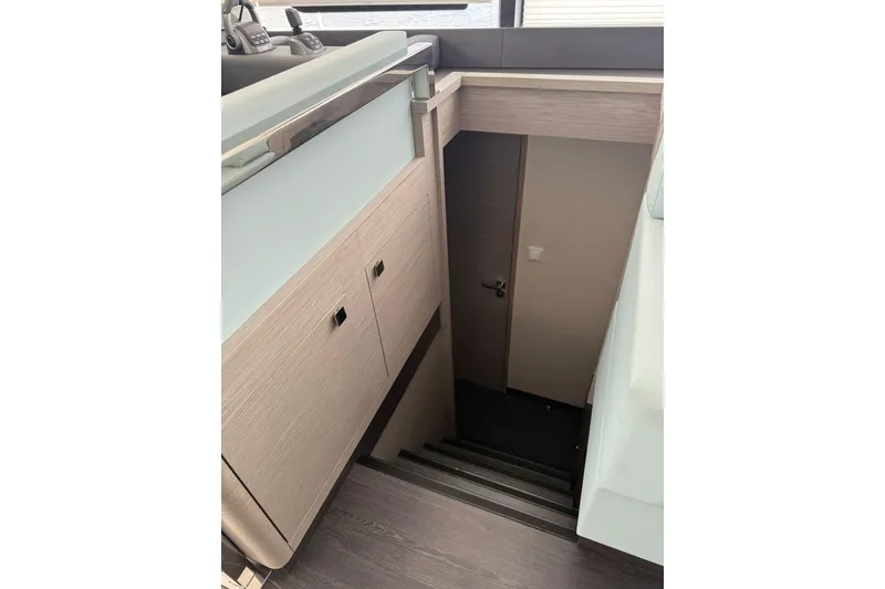 Slide: The Image of Interior staircase of 2024 Fountaine Pajot MY6 yacht, featuring modern wood finish. - 38