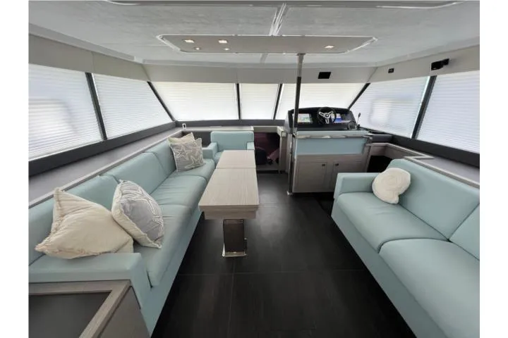 Slide: The Image of 2024 Fountaine Pajot Motor Yacht 44 docked by lush greenery under clear blue skies. - 5