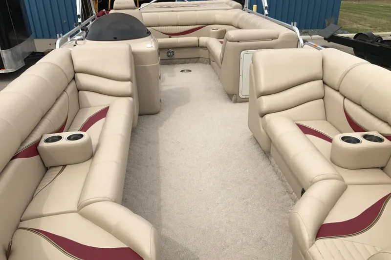 Slide: The Image of Luxurious interior of 2008 South Bay 822CR TT pontoon boat with beige seating and cup holders. - 13
