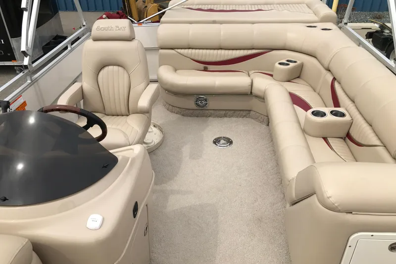 Slide: The Image of 2008 South Bay 822CR TT pontoon boat interior with beige seating and steering console. - 16