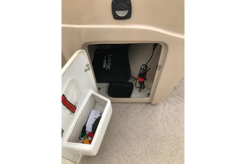 Slide: The Image of Storage compartment in 2008 South Bay 822CR TT boat with cables and accessories. - 17