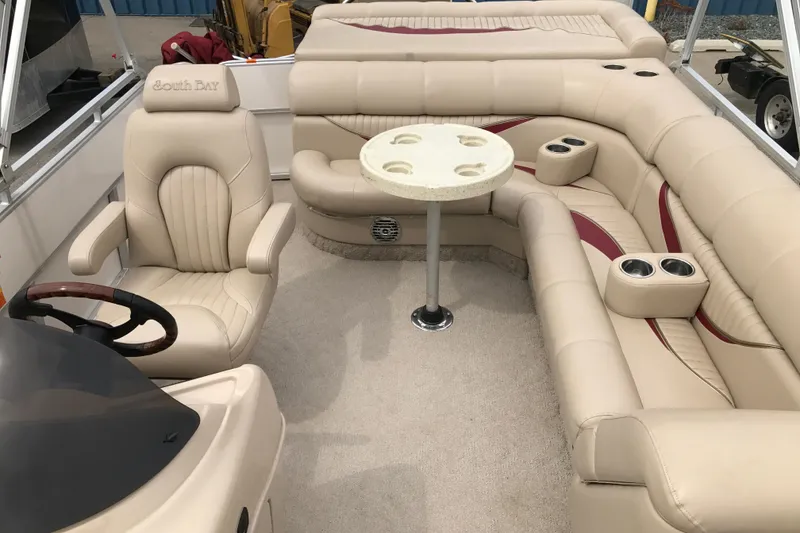 Slide: The Image of 2008 South Bay 822CR TT boat interior with beige seating and table. - 18