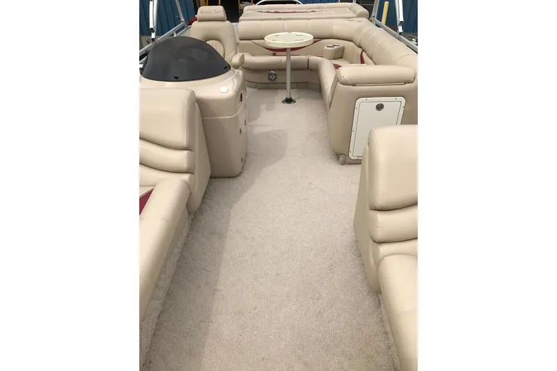 Slide: The Image of 2008 South Bay 822CR TT pontoon boat interior with beige seating and table. - 19