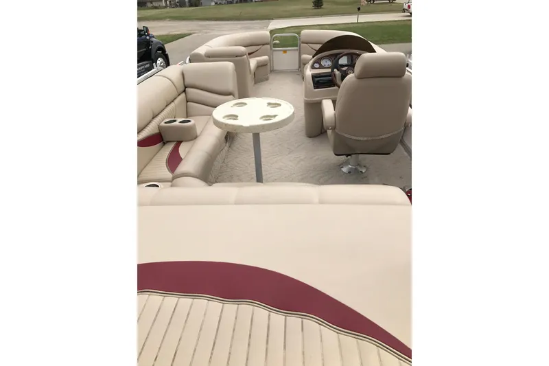 Slide: The Image of 2008 South Bay 822CR TT pontoon boat interior with beige seating and steering console. - 21