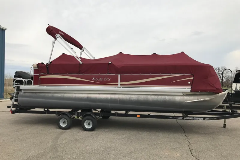 Slide: The Image of 2008 South Bay 822CR TT pontoon boat with maroon cover on trailer. - 5