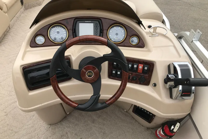 Slide: The Image of 2008 South Bay 822CR TT boat dashboard with steering wheel and control panel. - 7