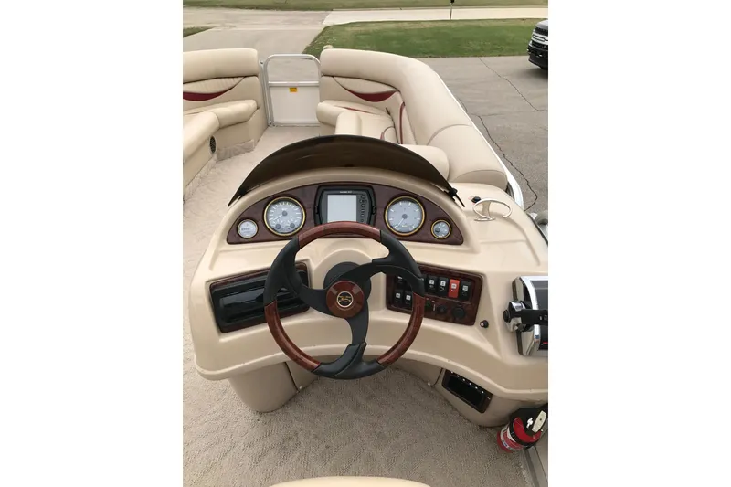 Slide: The Image of 2008 South Bay 822CR TT boat dashboard with steering wheel and control panel. - 8