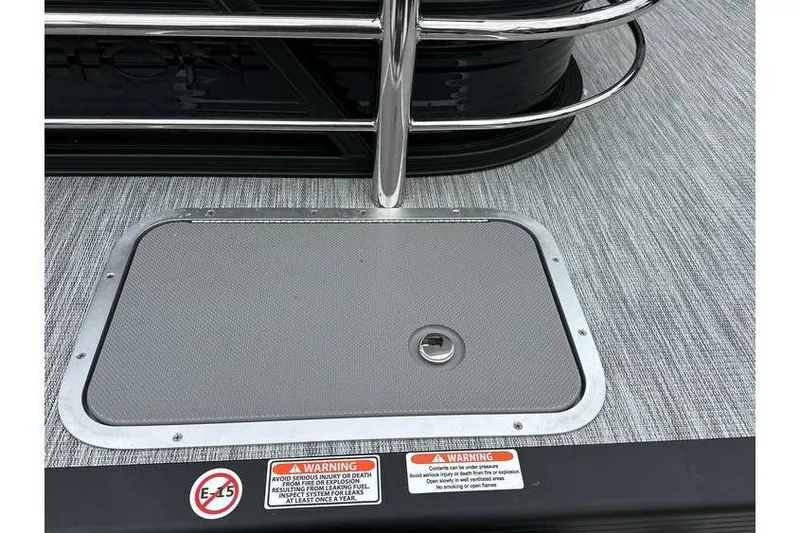 Slide: The Image of 2026 Bennington 22 SSB Tritoon deck with safety warnings and hatch. - 22