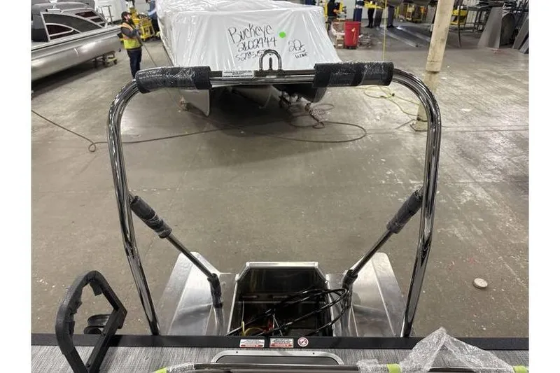 Slide: The Image of 2026 Bennington 22 SSB SwingBack Tritoon with Yamaha 150 Hp in a warehouse setting. - 8