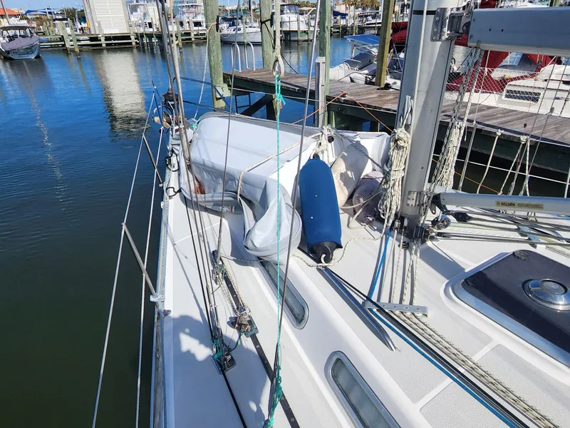 Slide: The Image of 1989 Granada 375 Atlantica sailboat docked at a marina, showcasing deck and rigging details. - 10