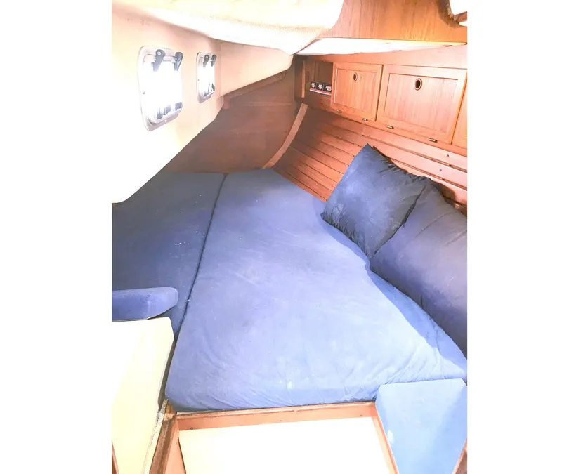 Slide: The Image of Cozy cabin interior of 1989 Granada 375 Atlantica sailboat with blue bedding and wooden accents. - 14