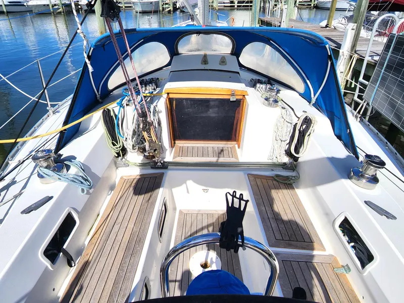 Slide: The Image of 1989 Granada 375 Atlantica sailboat cockpit with blue canopy and wooden deck. - 5
