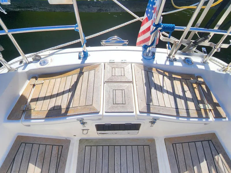 Slide: The Image of 1989 Granada 375 Atlantica yacht deck with wooden panels and American flag. - 8
