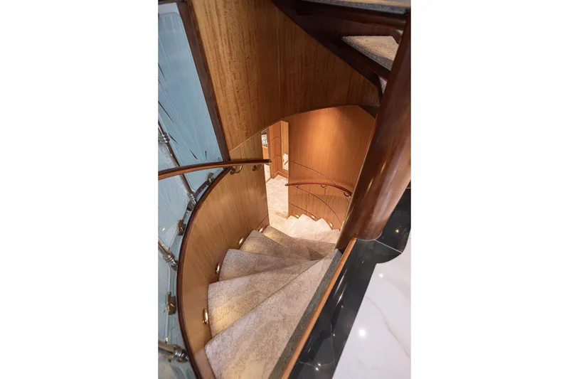 Slide: The Image of Elegant spiral staircase on 2003 Cheoy Lee Trideck yacht, featuring wood and glass accents. - 18