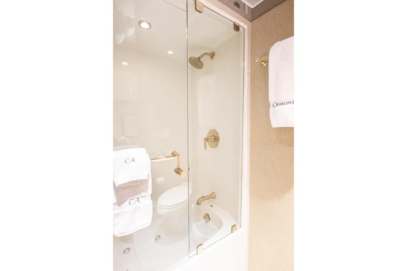 Slide: The Image of Luxurious bathroom shower in 2003 Cheoy Lee Trideck yacht, featuring elegant gold fixtures. - 24
