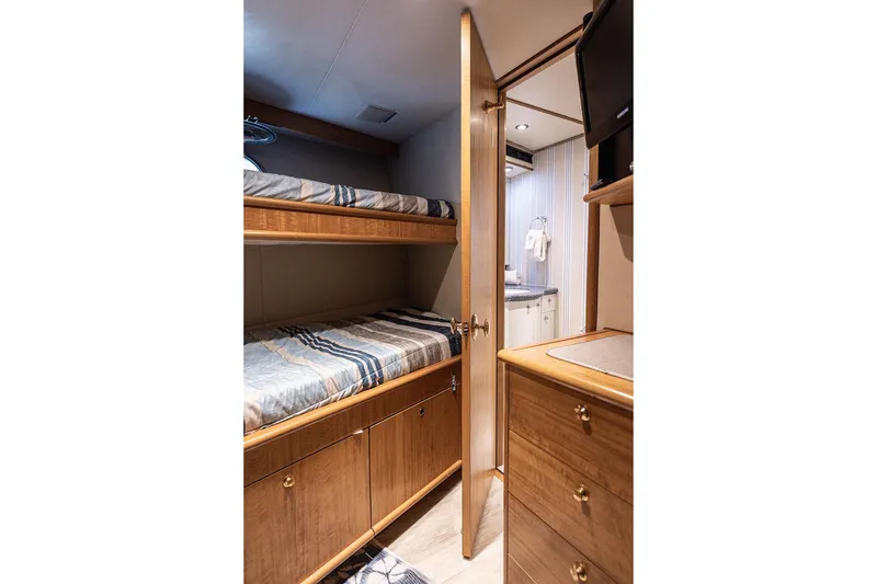 Slide: The Image of Interior of 2003 Cheoy Lee Trideck yacht with bunk beds and wooden cabinetry. - 27
