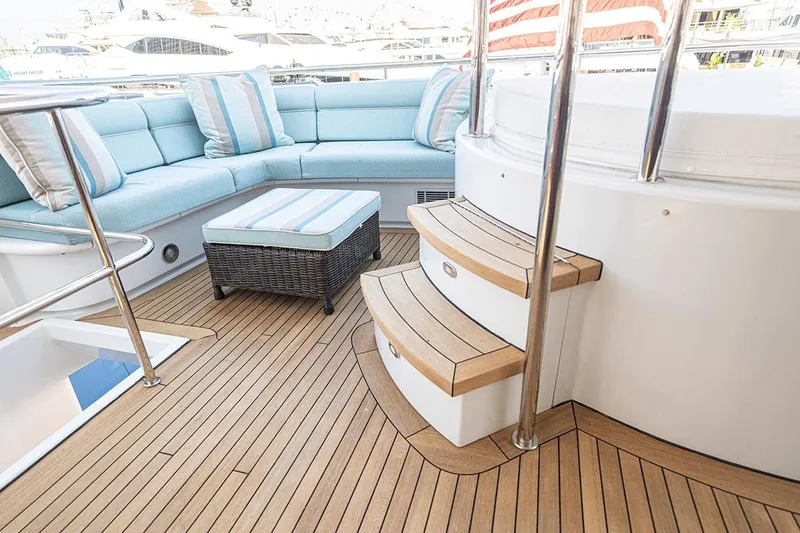 Slide: The Image of Luxurious 2003 Cheoy Lee Trideck yacht deck with elegant seating and wooden steps. - 29