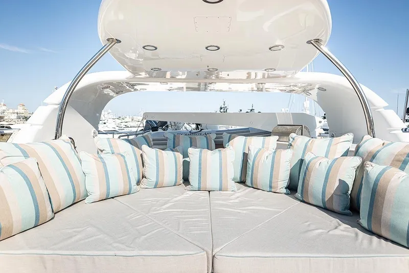 Slide: The Image of Luxurious 2003 Cheoy Lee Trideck yacht deck with striped cushions and elegant seating. - 31