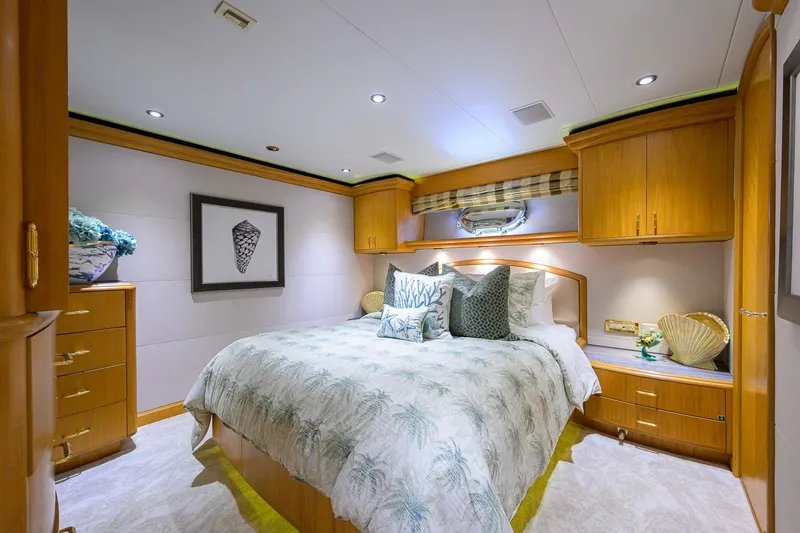 Slide: The Image of Luxurious bedroom interior on 2003 Cheoy Lee Trideck yacht, featuring elegant wood cabinetry and plush bedding. - 36