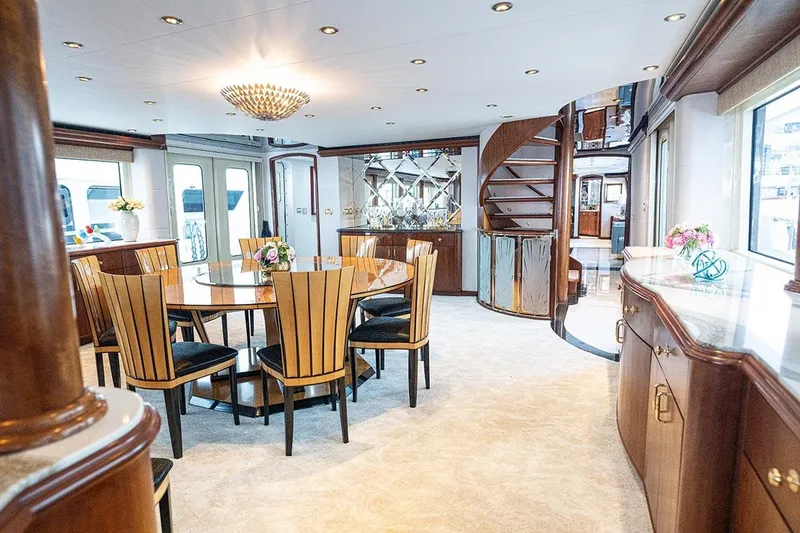 Slide: The Image of Luxurious dining area on 2003 Cheoy Lee Trideck yacht with elegant decor and spiral staircase. - 5