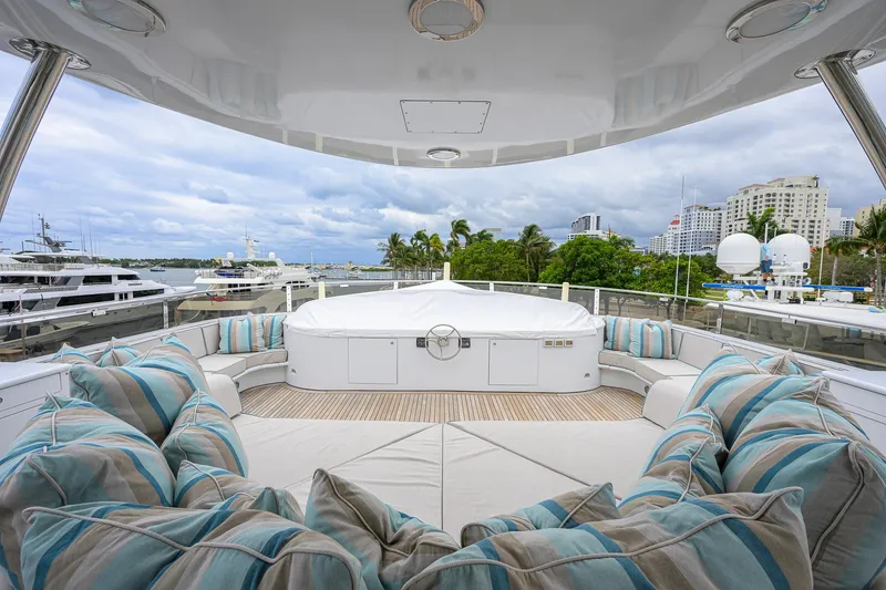 Slide: The Image of Luxurious 2003 Cheoy Lee Trideck yacht deck with plush seating and scenic marina view. - 58