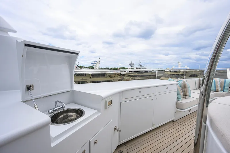 Slide: The Image of Luxurious 2003 Cheoy Lee Trideck yacht deck with sink, seating, and scenic marina view. - 59