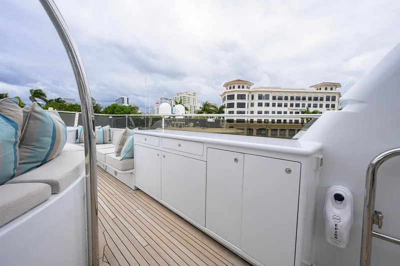 Slide: The Image of Luxurious 2003 Cheoy Lee Trideck yacht deck with seating and scenic waterfront view. - 60