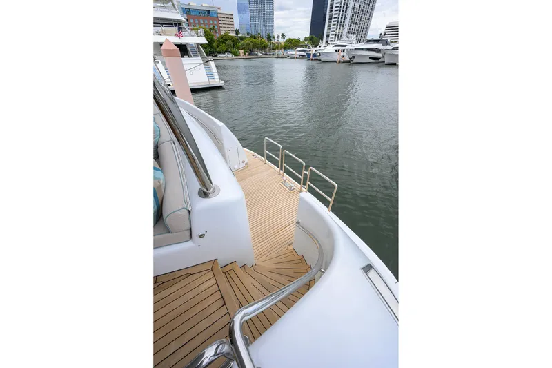 Slide: The Image of 2003 Cheoy Lee Trideck yacht with teak deck, docked in a marina. - 68