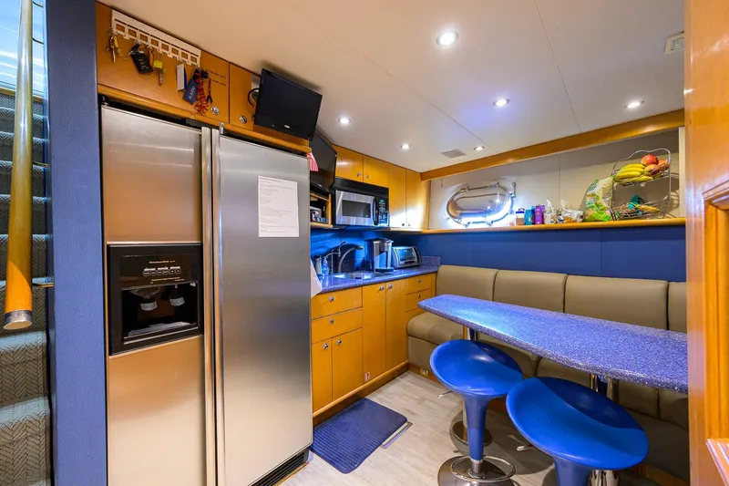 Slide: The Image of Luxurious 2003 Cheoy Lee Trideck yacht kitchen with modern appliances and cozy seating area. - 76