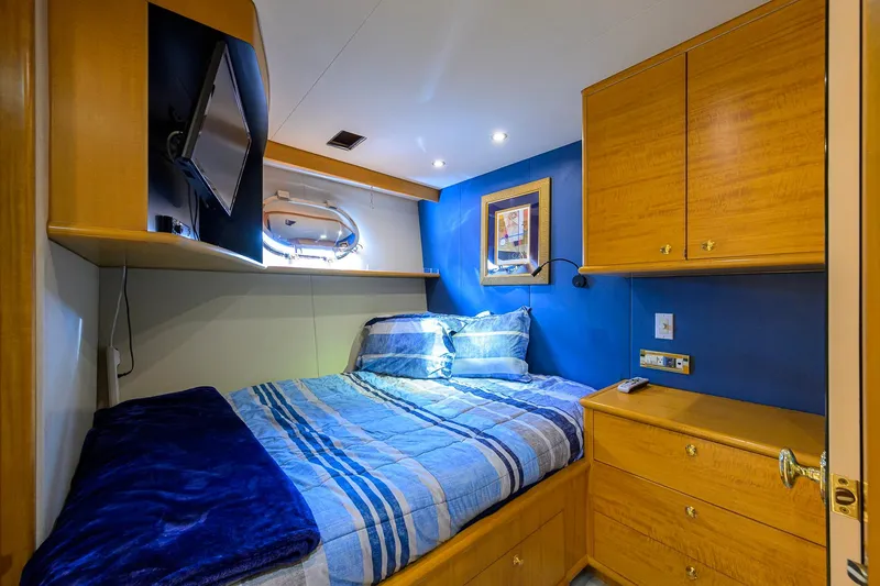 Slide: The Image of Cozy bedroom on 2003 Cheoy Lee Trideck yacht with blue accents and wood cabinetry. - 78