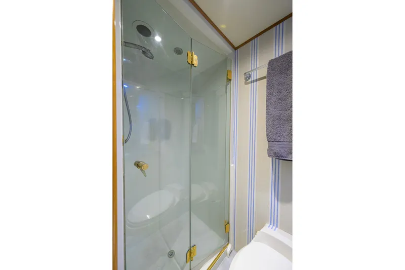 Slide: The Image of Luxurious shower in 2003 Cheoy Lee Trideck yacht with glass doors and modern fixtures. - 79