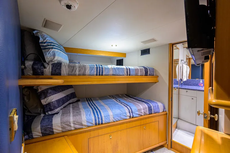 Slide: The Image of Bunk beds in 2003 Cheoy Lee Trideck yacht cabin with striped bedding and ensuite bathroom. - 82