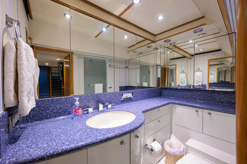 Slide: The Image of Luxurious bathroom on 2003 Cheoy Lee Trideck yacht with blue countertop and mirrored walls. - 83