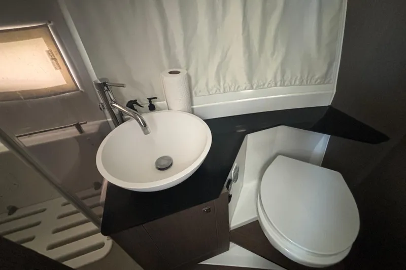 Slide: The Image of 2024 Jeanneau NC Weekender 1095 Fly bathroom with modern sink and toilet. - 22